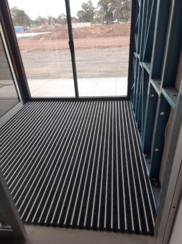 Commercial aluminium entrance mat/grill fitted at the fire station sliding glass entry doors