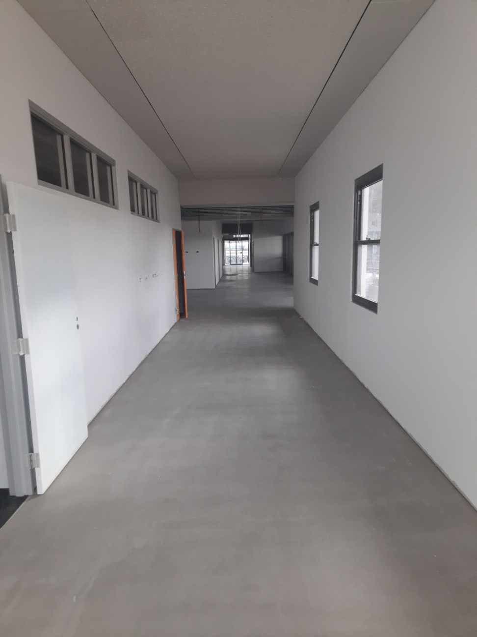Corridor with completed Gerflor LVT tiles and windows along one side