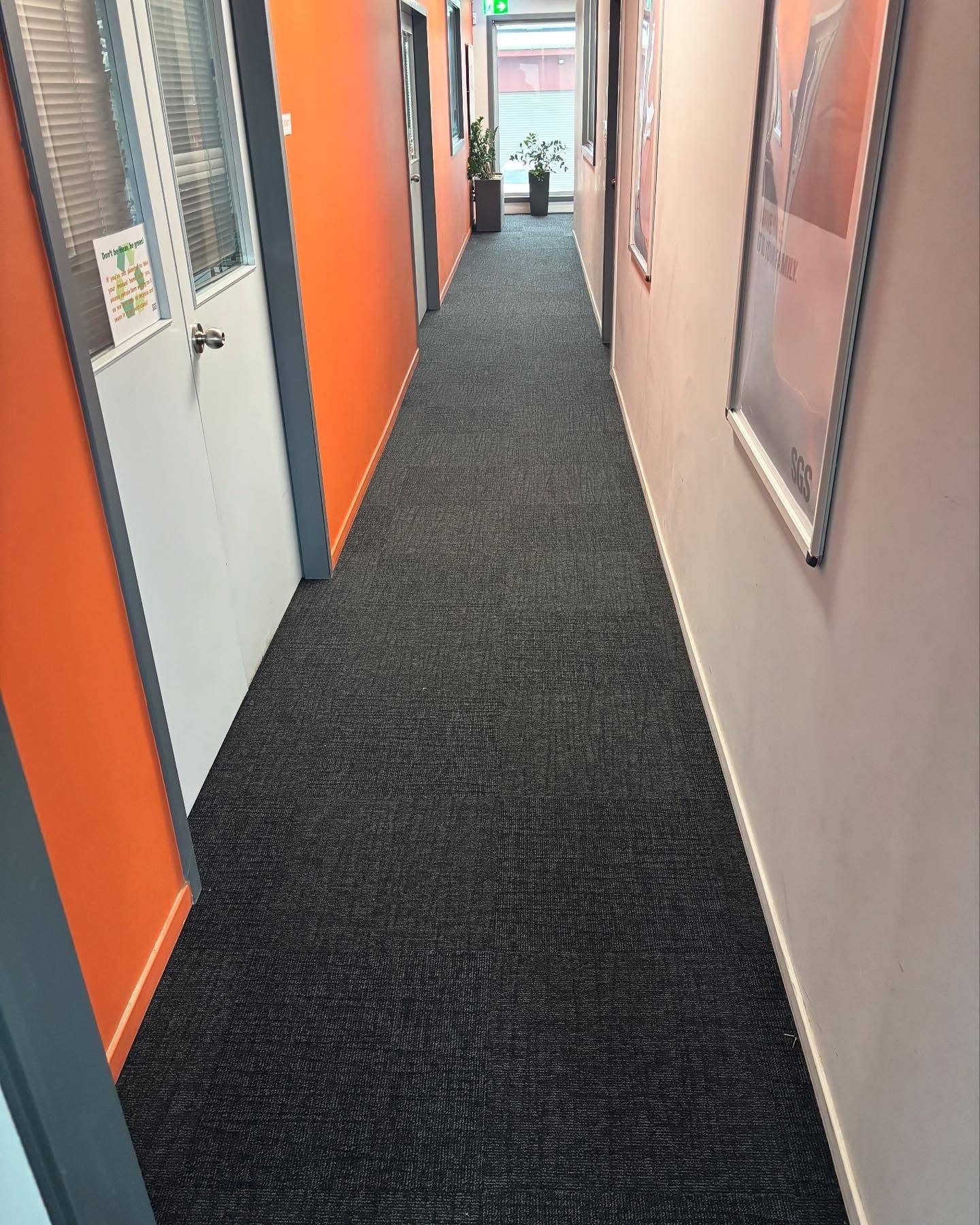 Office corridor with dark carpet tiles