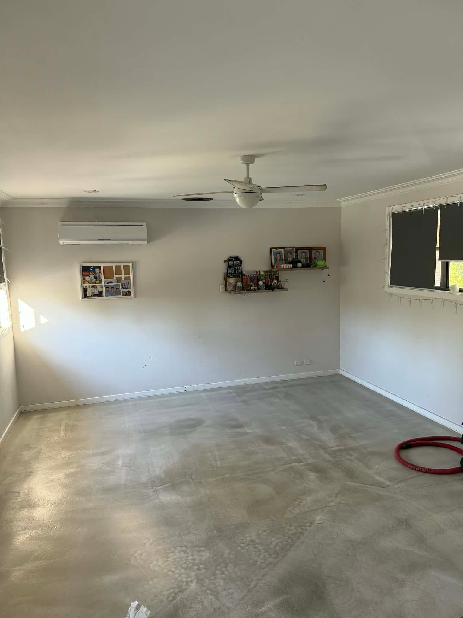 Living room before installation — bare concrete subfloor