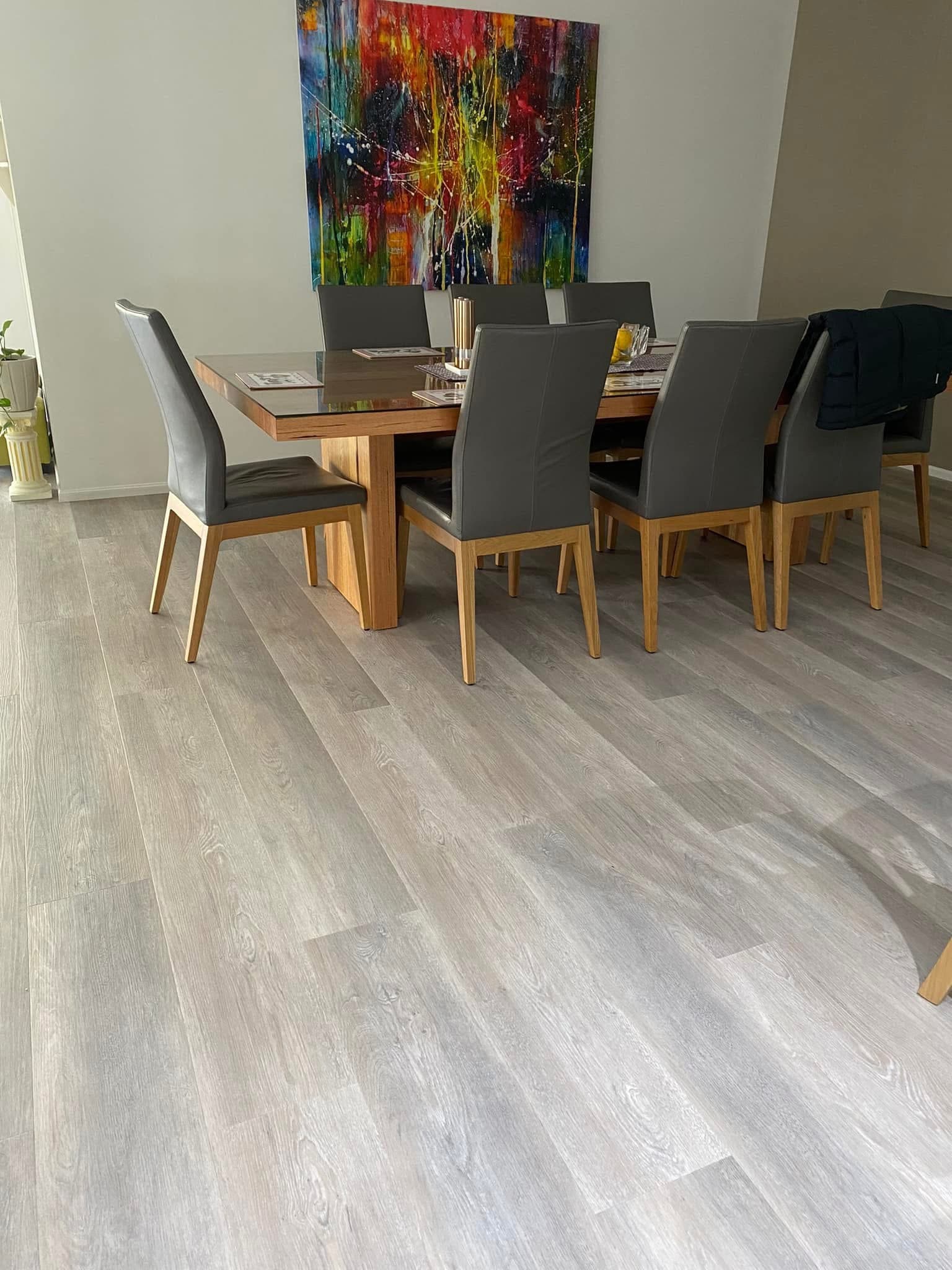 Dining room vinyl plank flooring with large timber dining table