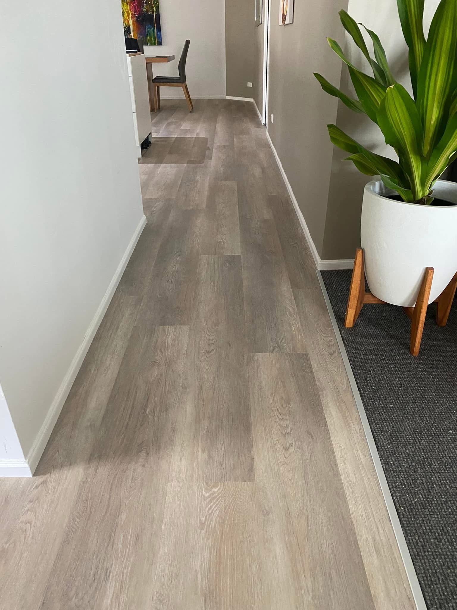 Hallway vinyl plank flooring leading to dining area