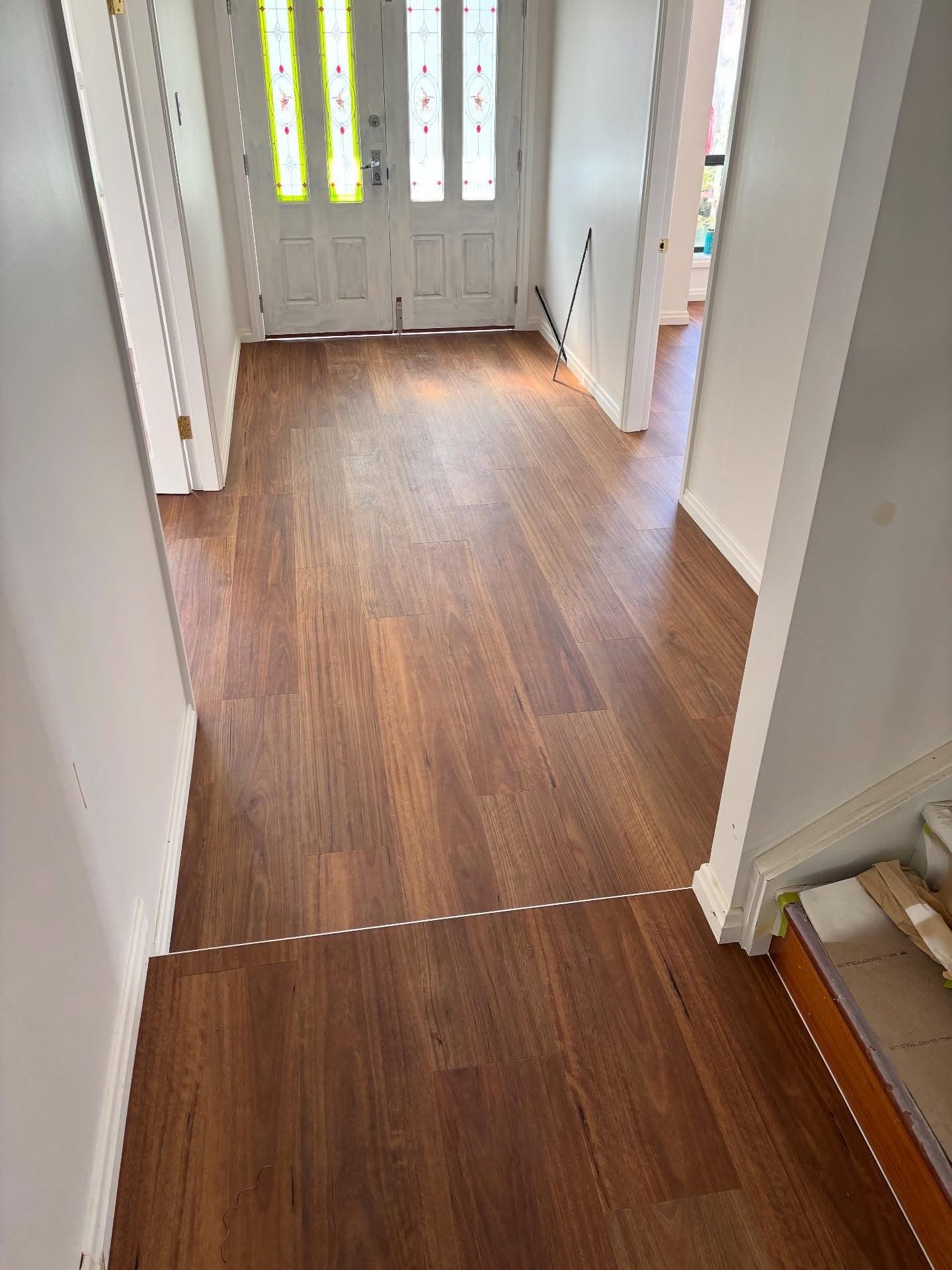 Entry hallway with new vinyl plank flooring looking into the living area — Gateshead