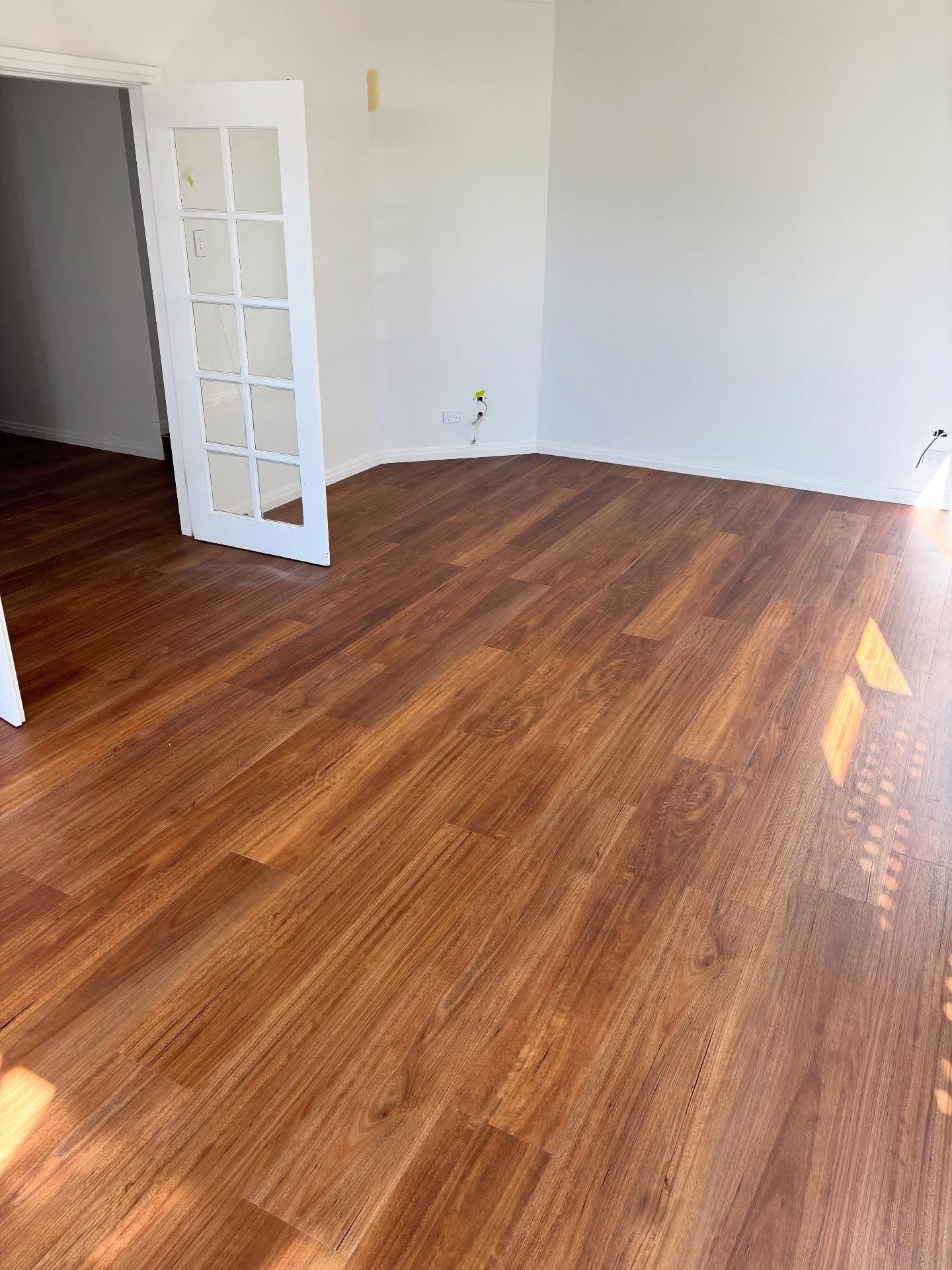 Open living area with warm oak vinyl plank flooring installed throughout — Gateshead