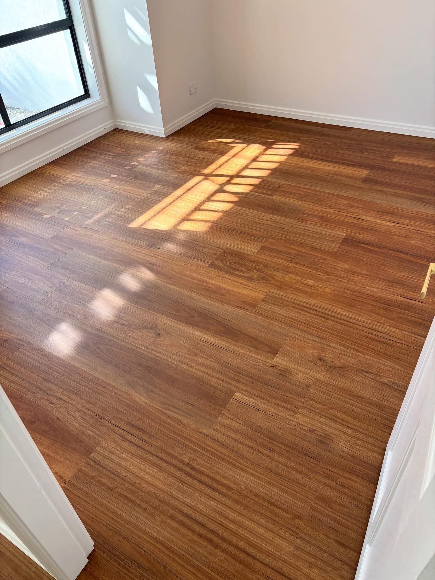 Bedroom with new vinyl plank flooring replacing old carpet — Gateshead