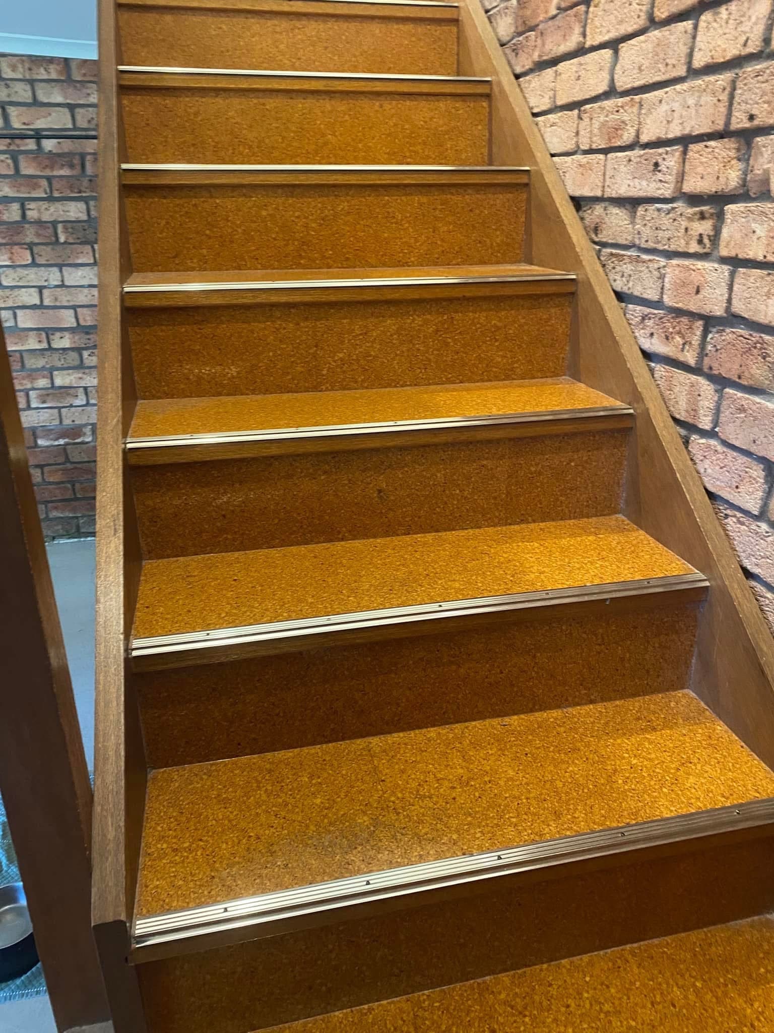 Full staircase view before renovation showing original orange carpet treads