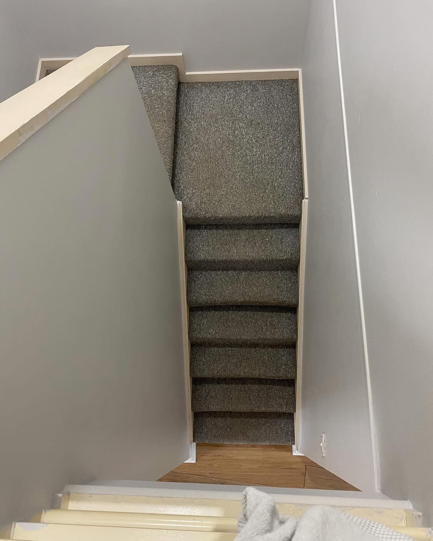 Before: staircase with old grey carpet, looking down from top landing