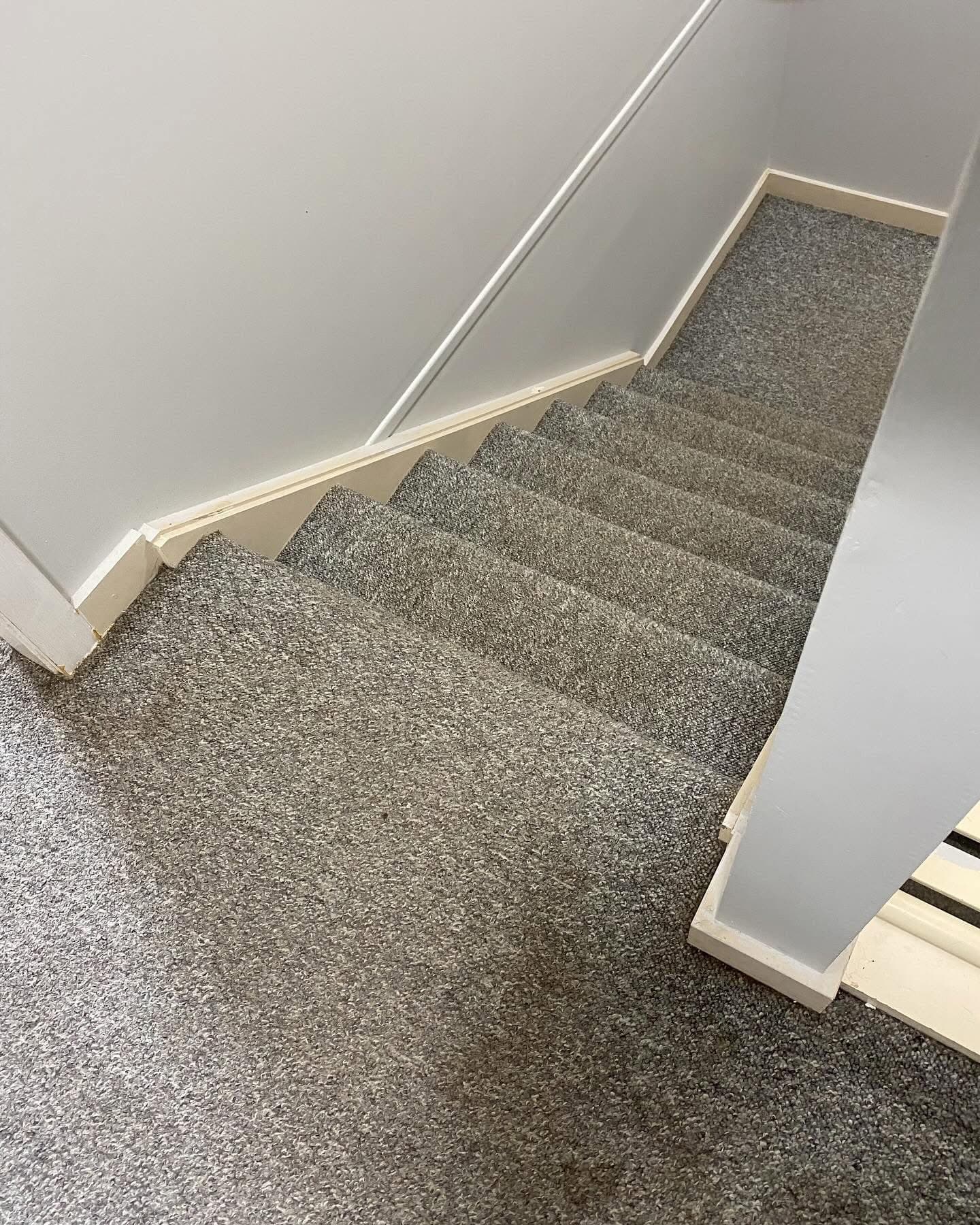 Before: grey carpet on stairs and landing viewed from below