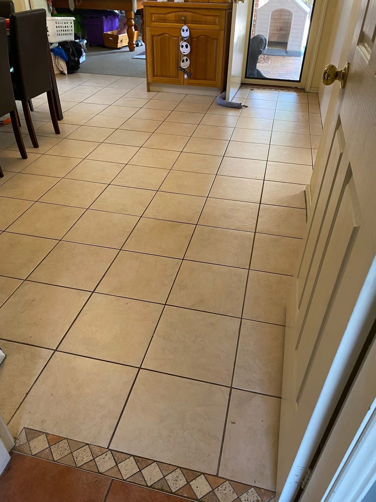 Before: old beige kitchen floor tiles with original cabinetry