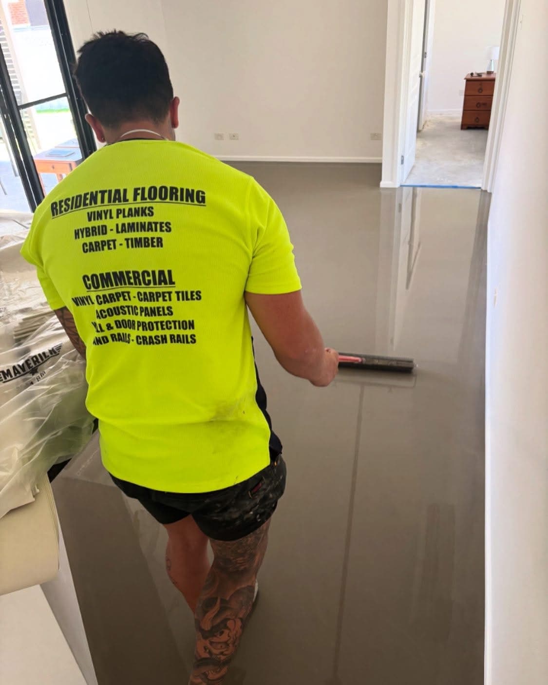 DFO installer applying self-levelling compound to bedroom subfloor during preparation