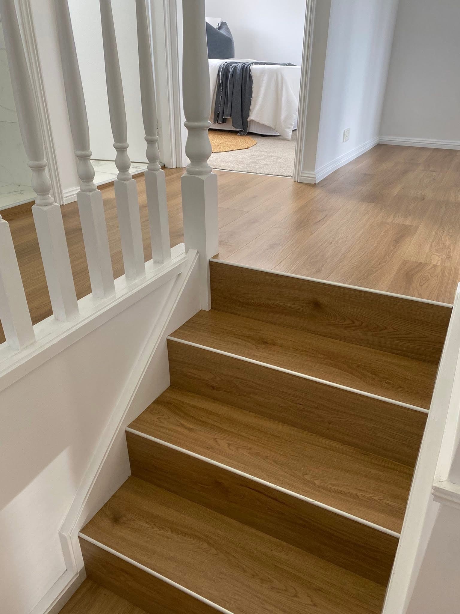 Top of staircase and upstairs landing with vinyl plank running through to bedroom doorway