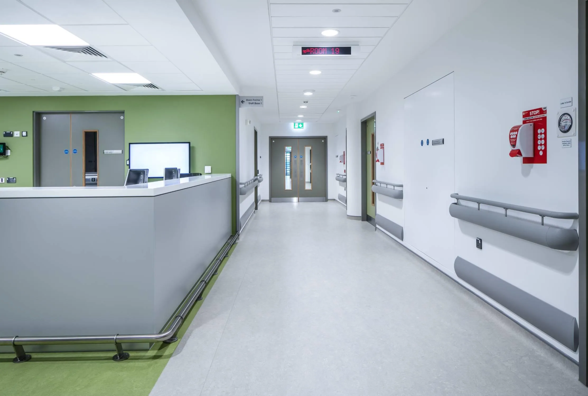 Hospital corridor with safety vinyl flooring, wall protection, and handrails installed by SPM in NSW